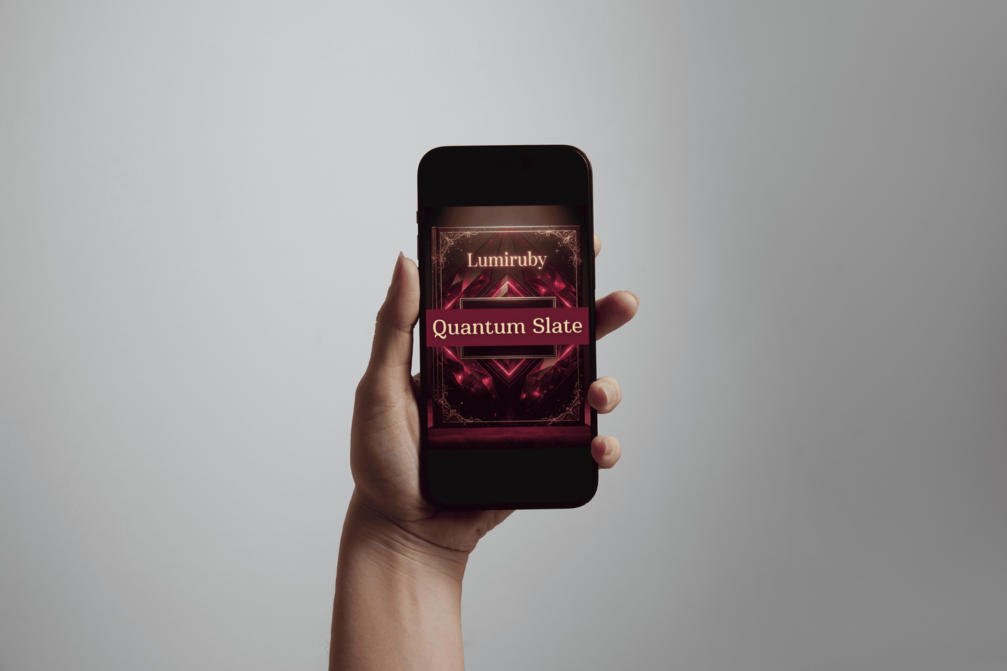 Hand holding a smartphone displaying the 'Lumiruby Quantum Slate' app on a gray background